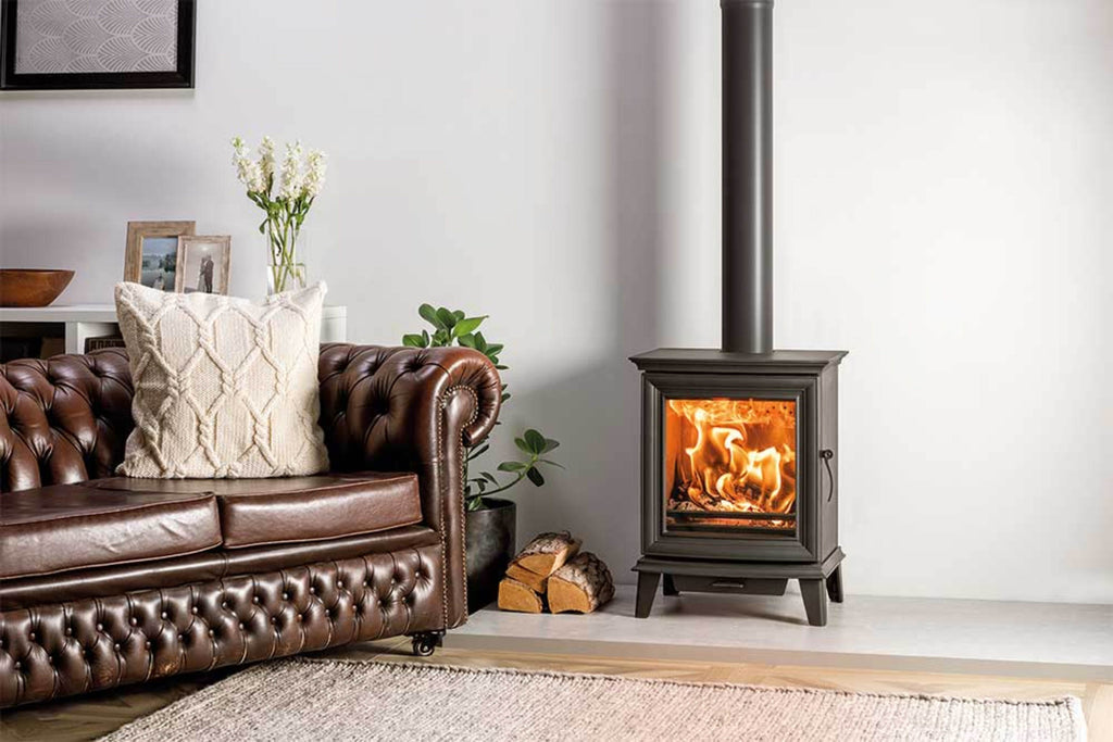 Chesterfield 5 Multi-fuel Ecodesign Stove freestanding in a living room next to a sofa