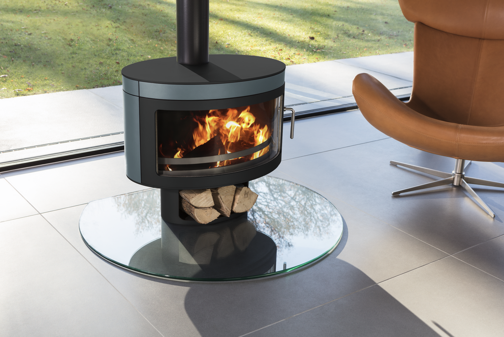 Future Fires - Panoramic FX1 8kW Wood Burning Stove on a glass hearth and a pedestal with logs