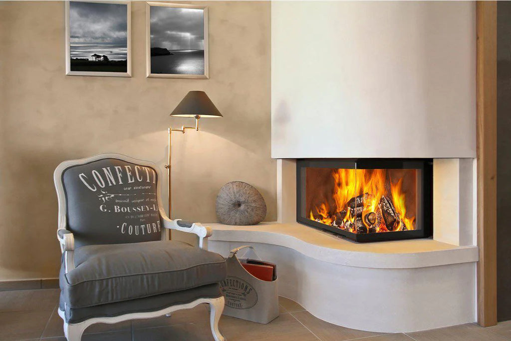 Fondis Ulys 900 black inset corner stove with flames next to a lounge armchair