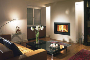 Fondis Ulys 700 black inset stove heating a living room at night