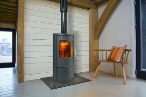 Opus - Harmony - 7kW Multi-Fuel Stove on gray hearth in a minimalistic space