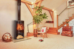 Harmony GLS 7kW Multi-Fuel Stove With Glass Door &amp; Log Store on glass hearth in a living area