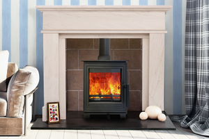 Woodford - Pankhurst Small 4.1kW Eco Design Wood Burning Stove with flames in a white fireplace suite