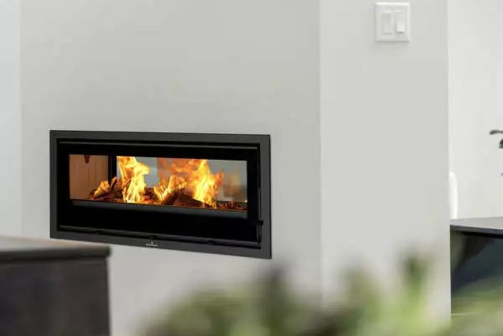 Bronpi - Cairo 90D - 13kW Wood Burning Inset Stove double sided with flames in a white wall